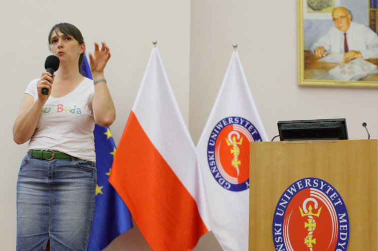 Frau Buda, czyli Magdalena Buda, przemawia podczas spotkania podsumowującego rok Kreatywnej Pedagogiki w auli GUM.