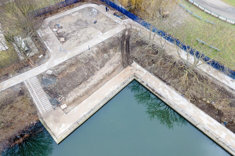 na zdjęciu z drona widać powstającą promenadę nad samą rzeką, widać też nieco wyżej przygotowywany plac rekreacyjny