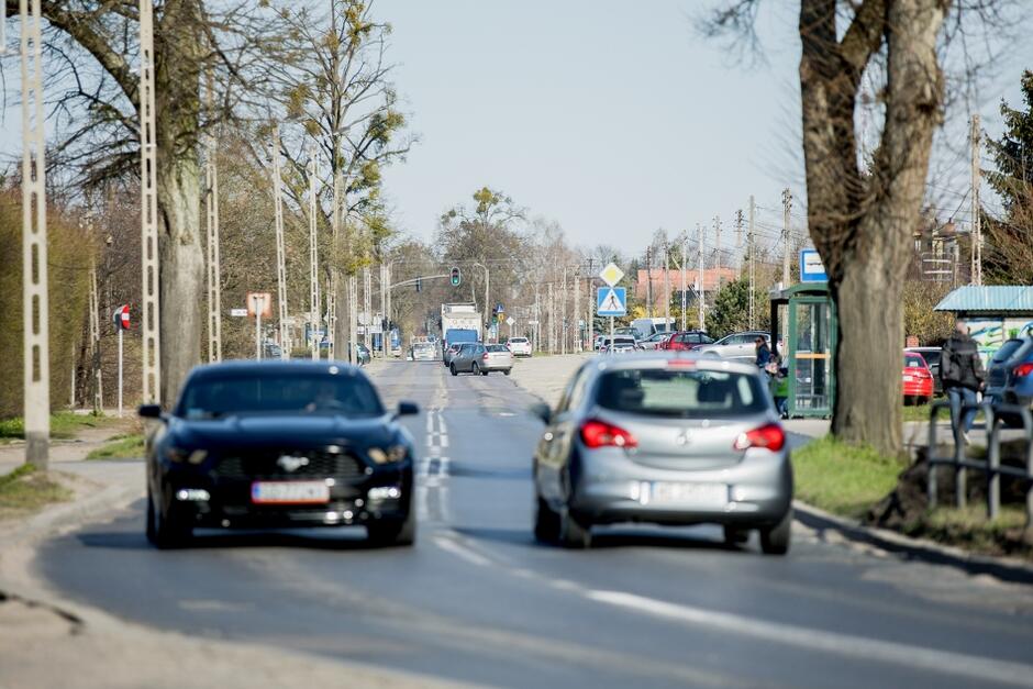na zdjęciu fragment ulicy kielnieńskiej, po której jadą dwa samochody osobowe w przeciwnych kierunkach