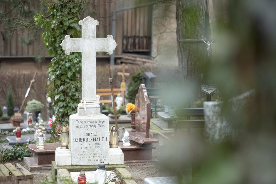 stone graves with crosses, among other graves in the cemetery