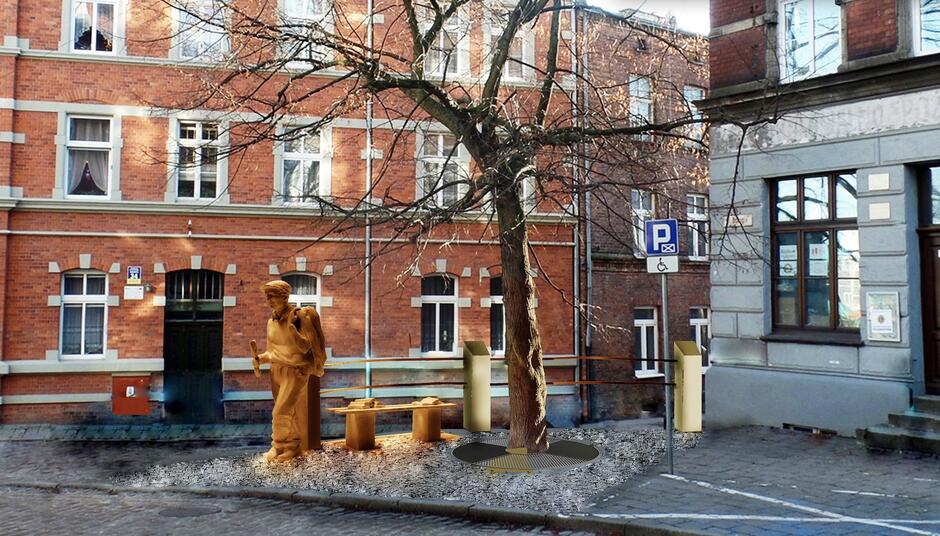 wizualizacja pomnika, mężczyzna stoi obok ławki, obok drzewo, w tle budynek z cegły