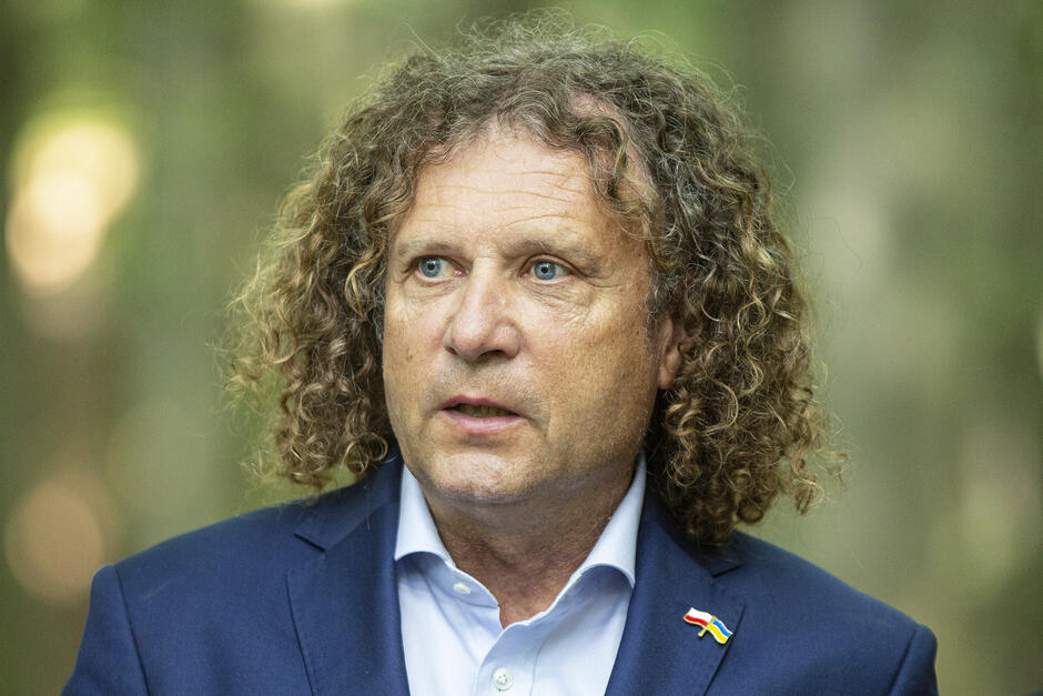 portret mężczyzny w średnim wieku w marynarce, z długimi kręconymi włosami 