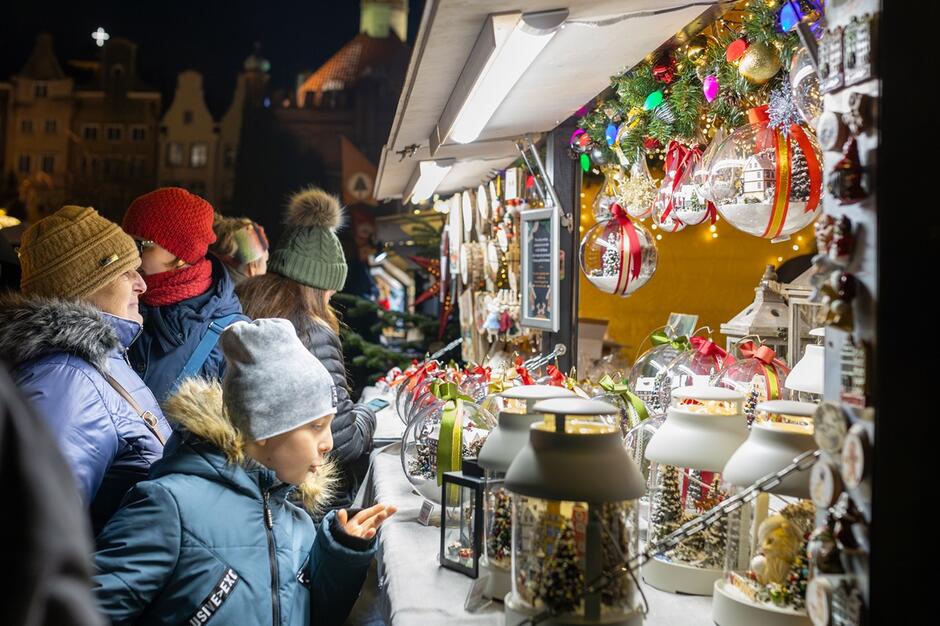 stoisko z ozdobami świątecznymi, zapatrzony kilkuletni chłopiec