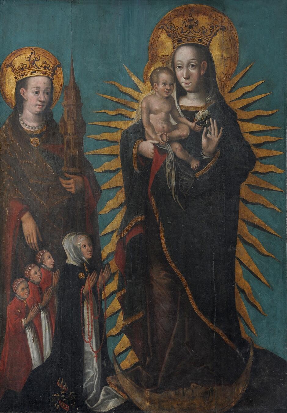 Na zdjęciu widzimy epitafium obrazowe przedstawiające Marię z Dzieciątkiem Jezus na ręku, otoczoną złotymi promieniami. Obok nich stoi święta Barbara trzymająca model wieży, a u ich stóp klęczą postaci w modlitewnych pozach, prawdopodobnie fundatorzy obrazu; całość znajduje się w Bazylice Mariackiej w Gdańsku