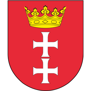 Herb przedstawia gotycką czerwoną tarczę. Na tarczy znajduje się złota korona otwarta i dwa równoramienne srebrne krzyże pod koroną.