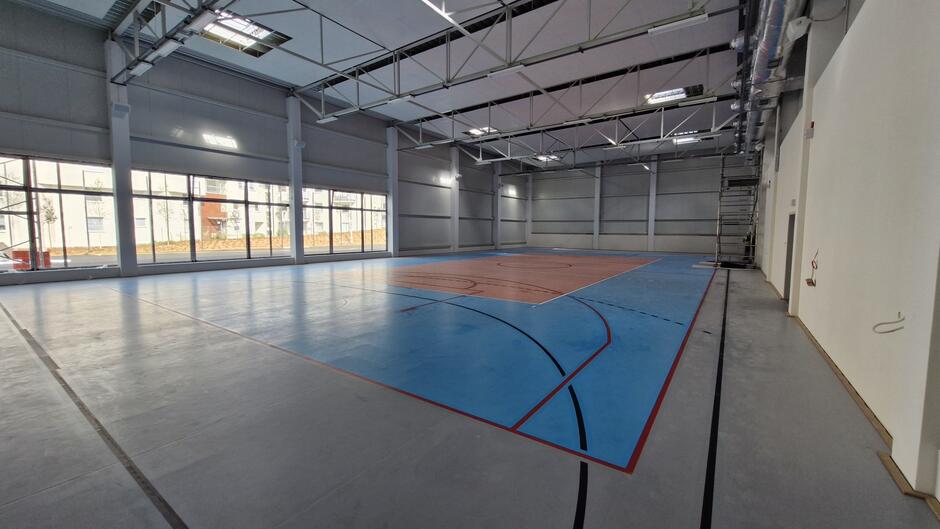 na zdjęciu sala gimnastyczna, na parkiecie wymalowano boisko