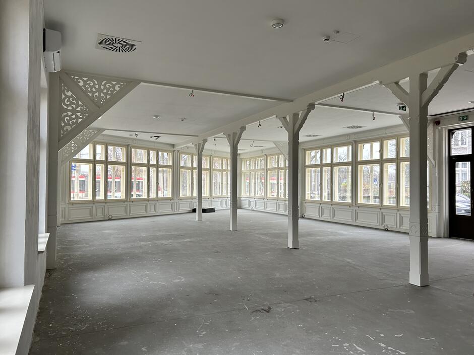 wnętrze budynku, jasna sala, bardzo przestrzenna z drewnianymi filarami także jasnymi