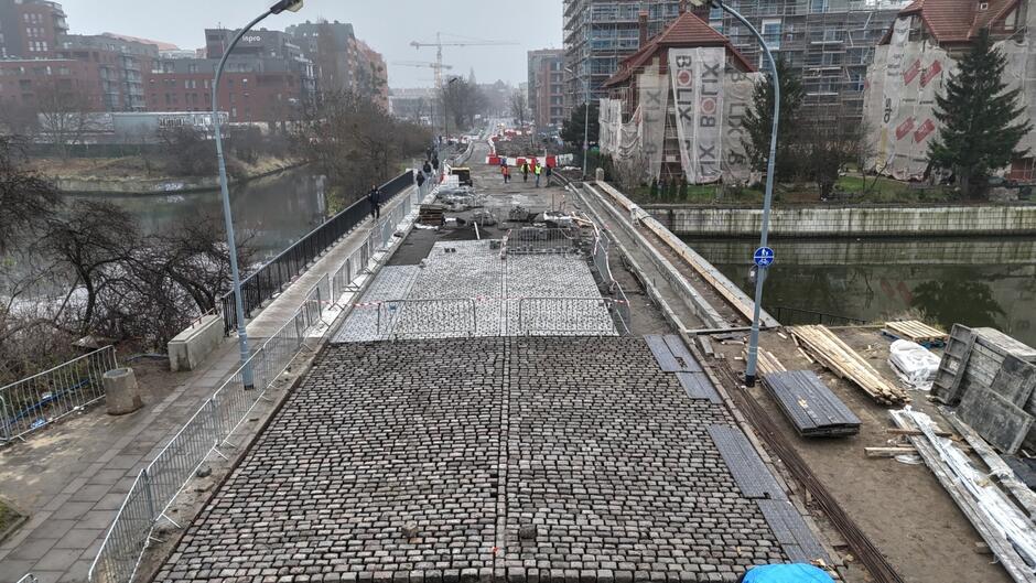 zdjęcie z drona, widać remontowany most, w tym częściowo ułożoną nawierzchnię brukową