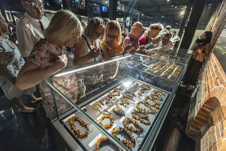Wystawy Muzeum Bursztynu. Kobiety oglądają biżuterię z bursztynu.