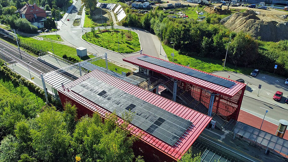zbliżenie na dwa dachy nad stacją kolejową, na których zamocowano panele fotowoltaiczne