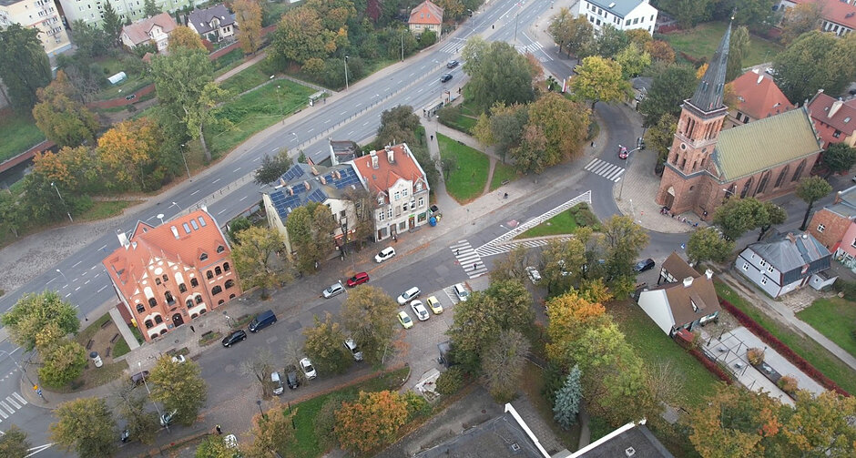 Widok z lotu ptaka na rynek: ratusz, dwie kamienice i kościół