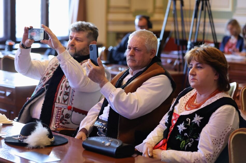 dwaj mężczyźni i kobieta w tradycyjnych strojach góralskich 