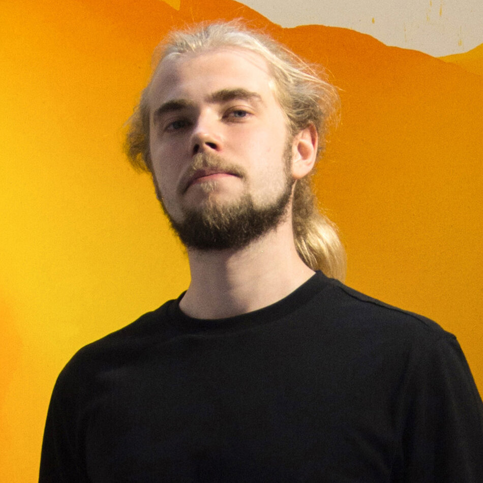 Na zdjęciu mężczyzna o długich włosach, z zarostem na twarzy.