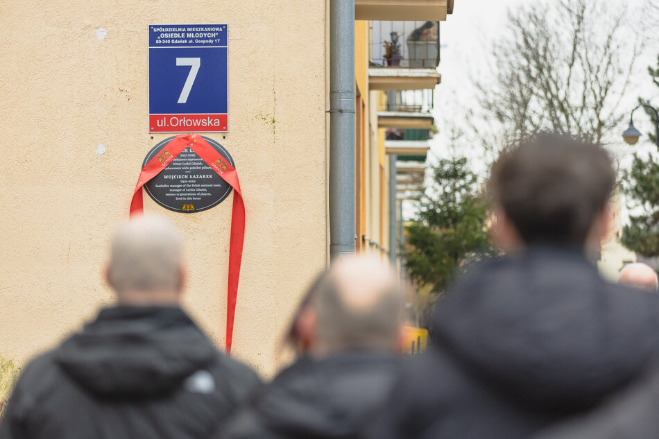 Blok mieszkalny z widoczną na ścianie szczytowej tablicą upamiętniającą Wojciecha Łazarka