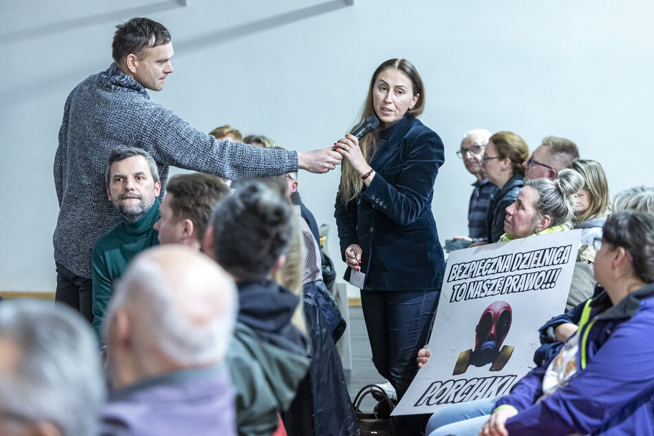 na zdjęciu kobieta w czarnym stroju mówi do mikrofonu który podsuwa jej mężczyzna stojący obok