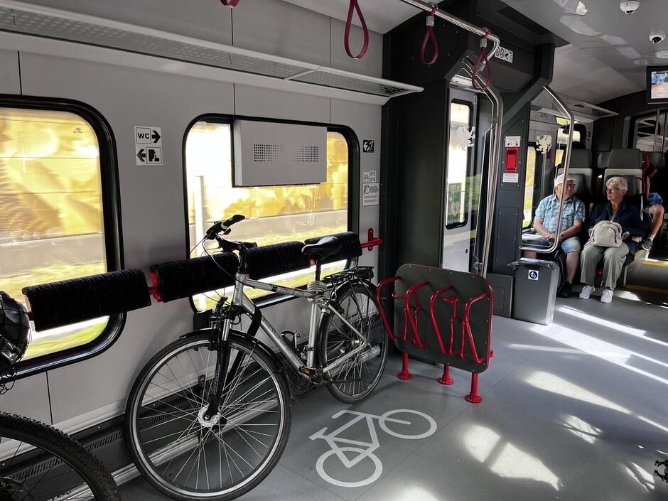Wnętrze pociągu i miejsce do przewozu rowerów wraz z rowerem