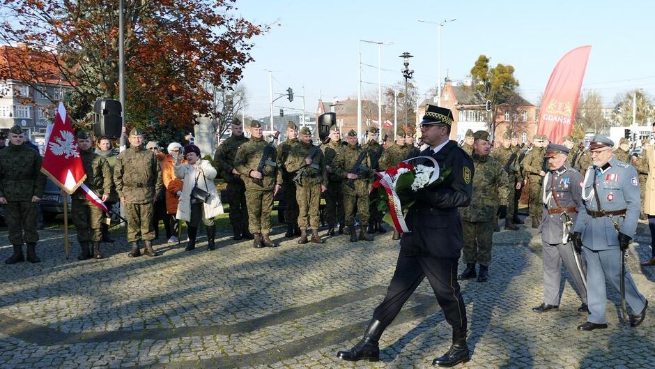 Straznik składa kwiaty pod pomnikiem józefa Piłsudskiego