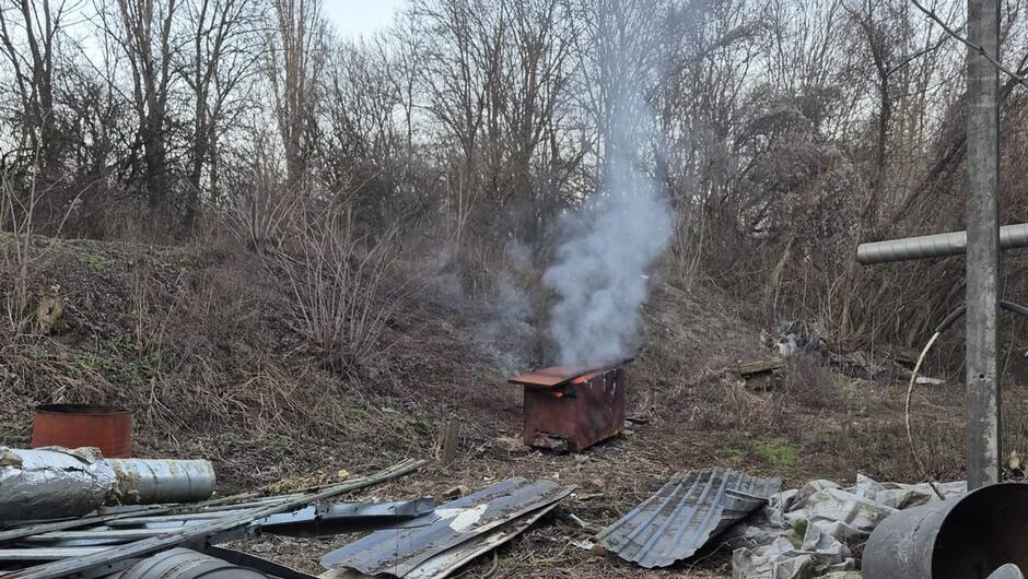 dymiący piec na polanie metalowe rury drzewa